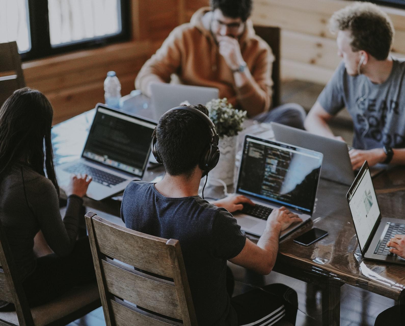 group of people using laptop computer